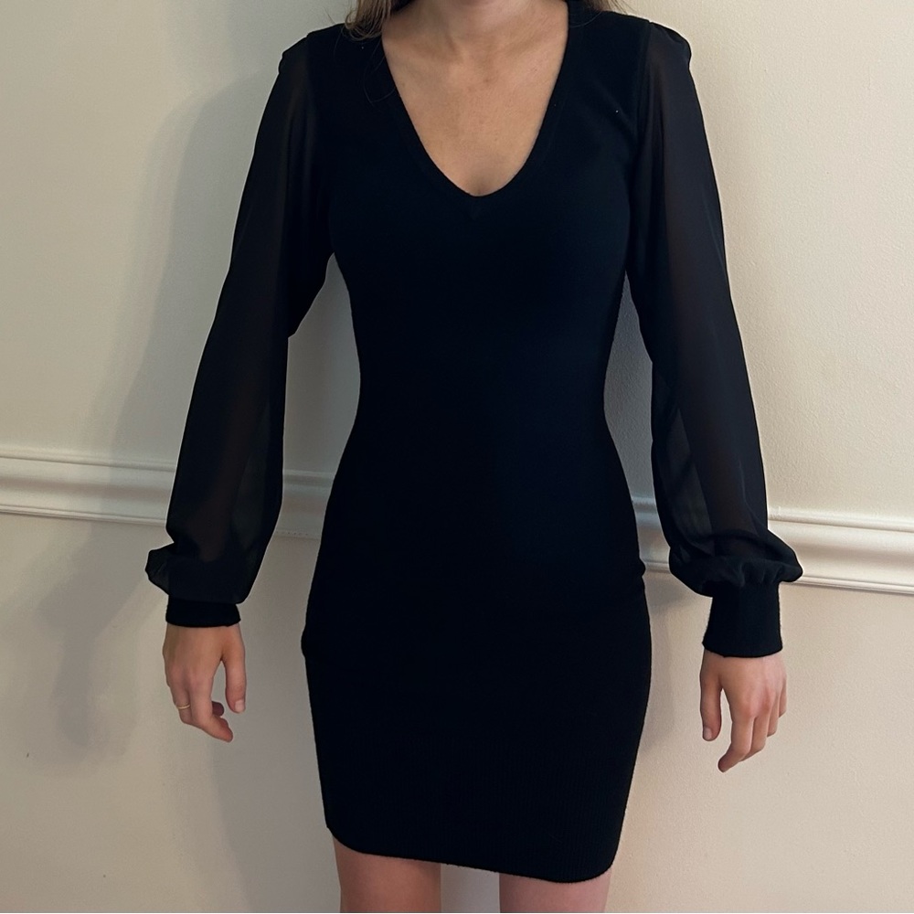 Bebe black sweater dress with sheer sleeves.